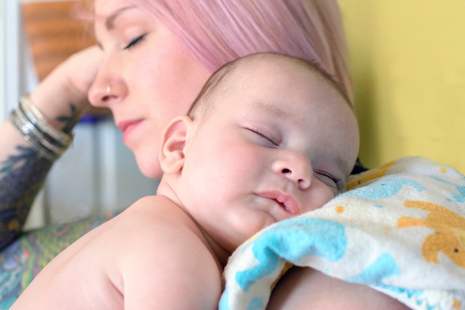 Parent comforting baby with fever using Cool Cuddle cooling vest